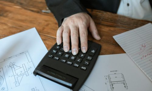 a close up shot of a person using a calculator